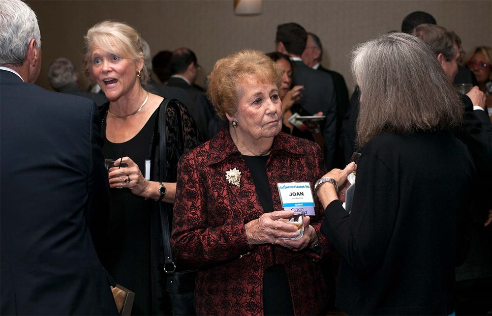 Joan Krumrey, wife of Bellwether Class of 2014 Honoree Norm Krumrey (center) with Gold Sponsor GHX’s Karen Conway behind her conversing with Bellwether Class of 2014 Honoree Joe Pleasant (far left).