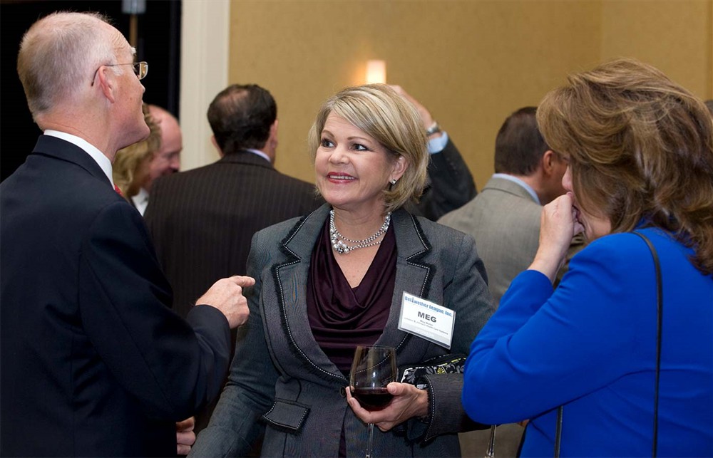 Bellwether Class of 2010 Honoree Curt Selquist (left) gestures with Johnson & Johnson Health Care System’s Meg Walter (center) and Pam Dickerson (right).
