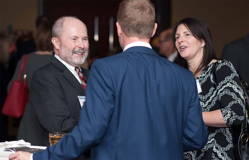 Bellwether League Inc. Co-Founder and Founding Chairman Jamie Kowalski enjoys a laugh with Corporate Sponsor MedSpeed’s Jake Crampton (center, back to camera) and Bonni Kaplan DeWoskin (right) during the VIP reception.