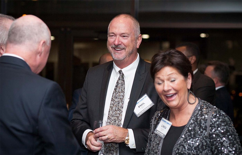 Corporate Sponsor Mercy’s Phil Wheeler (center) and Linda Knodel (right) share a lighter moment during the VIP reception with Bellwether League Inc. Board Member Vance Moore (left).