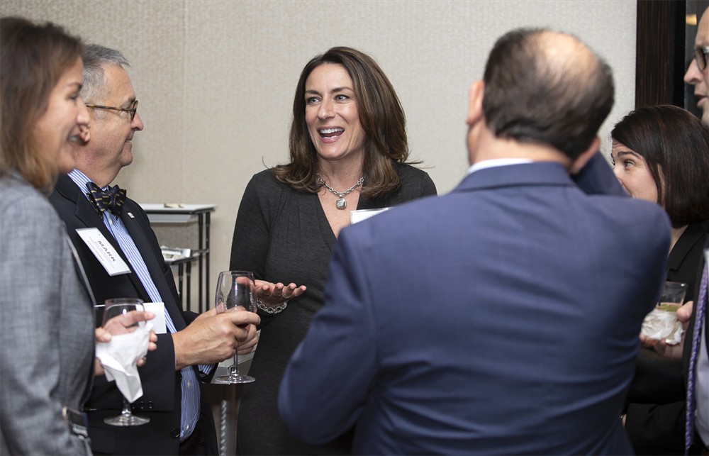 Sharon Toscano (center) with Bellwether League’s Mark Van Sumeren (left) and HealthCare Links’ Maria Hames (far left) with Nick Toscano (Bellwether Class of 2018) (right, back to camera).