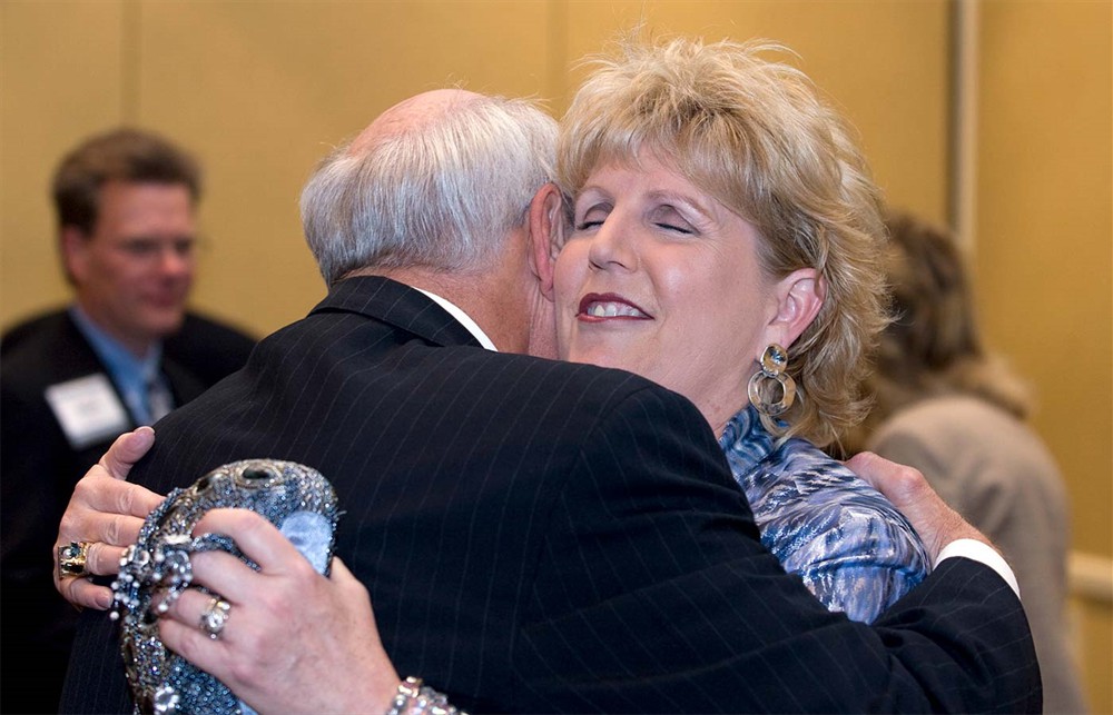 Bellwether Class of 2010 Honoree Gil Minor III appreciatively hugs CareFusion’s Cathy Specht.