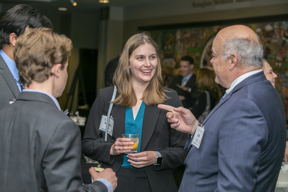 Trinity Health's Ed Hisscock (Bellwether Class of 2022) makes a point with University of Michigan capstone project students Laura Ely, Jeremy Segal (back to camera) and Advaidh Venkat (background).