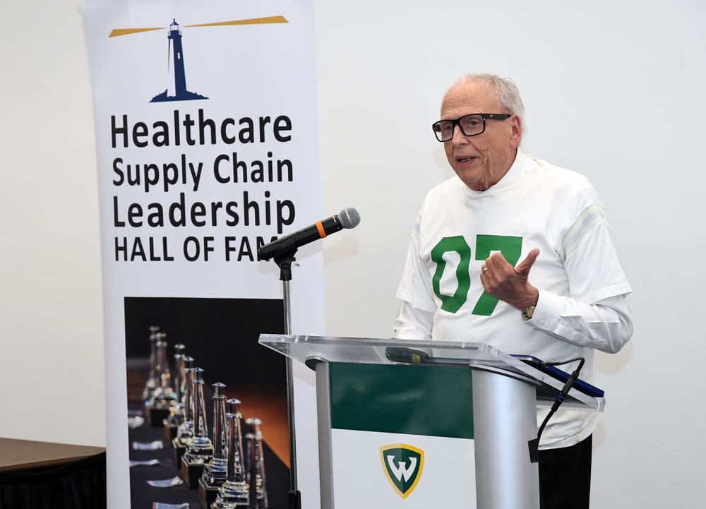 Wearing a special commemorative T-shirt, Arizona State University’s Eugene Schneller, Ph.D., Bellwether Class of 2024, introduces Jo Klein (1949-2024), Bellwether Class of 2025. Klein’s spouse Bert Klein accepts the award via exclusive audio recording.