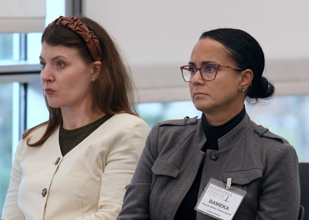 (Left to right): Western Michigan University's Anezka Viskova-Robertson, Ph.D., and Trinity Health's Dameka Miller, watch the WSU student presentation.
