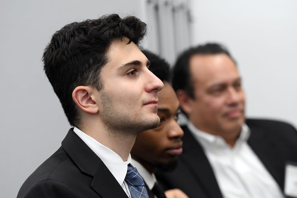 WSU supply chain student Daniel Saleem with Donnavin Jones and Kevin Ketels listen to the Bellwether Leadership Roundtable panelists.
