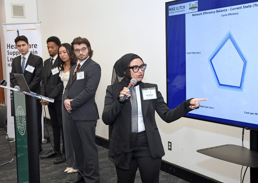 WSU supply chain student Zeinab Alhilal explains a slide on display.