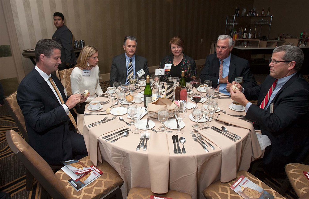 Table 12 with executives from DeRoyal, TECSYS, University HealthSystem Consortium/Novation and Johnson & Johnson Health Care Systems, prepares for dinner.