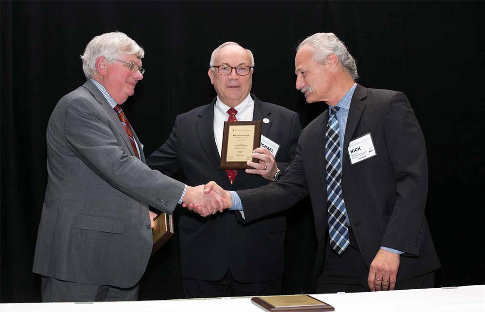 Nick Gaich presents John Strong and Michael Louviere as retiring Board Members.