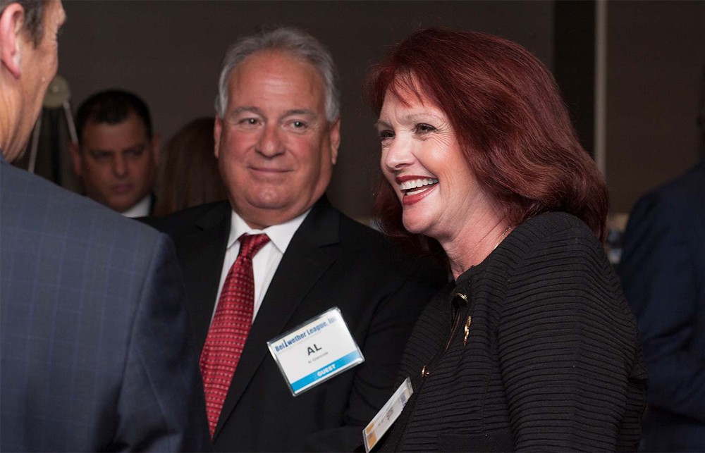 Bellwether Class of 2012’s Ray Seigfried (left with back to camera) chats with Founding/Platinum Sponsor Kimberly-Clark Health Care’s Keith Kuchta (right).