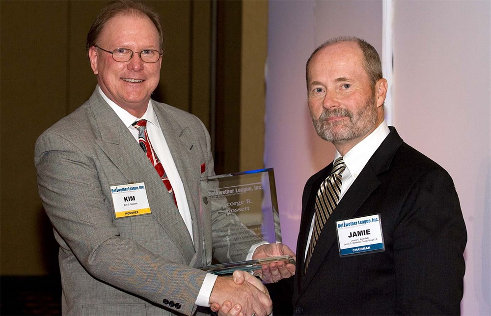 Kim C. Gossett accepts the award from Chairman Jamie Kowalski on behalf of his father.