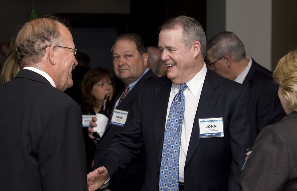 Bellwether League Inc. Secretary and Founding Board Member John Gaida (right) laughs with Frank Kilzer (Bellwether Class of 2010) (left) as Rand Ballard (center) from Founding Sponsor MedAssets looks back