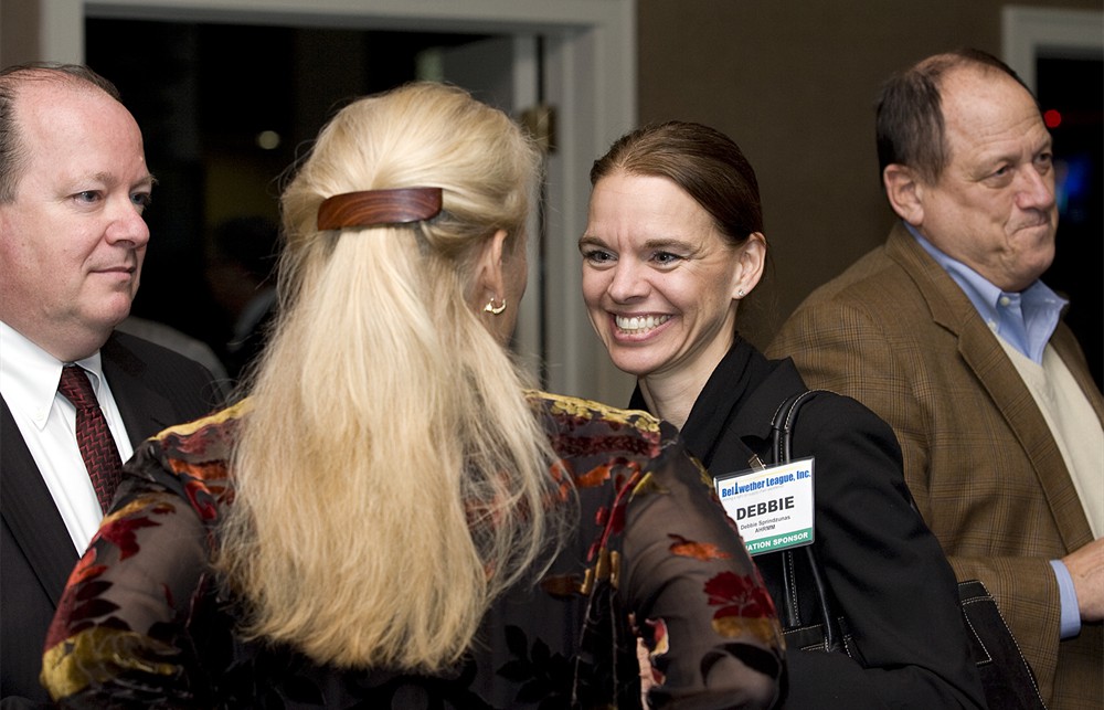 AHRMM’s Deb Sprindzunas with Karen Conway (back to camera) and GS1 US’ Bob Celeste (left)