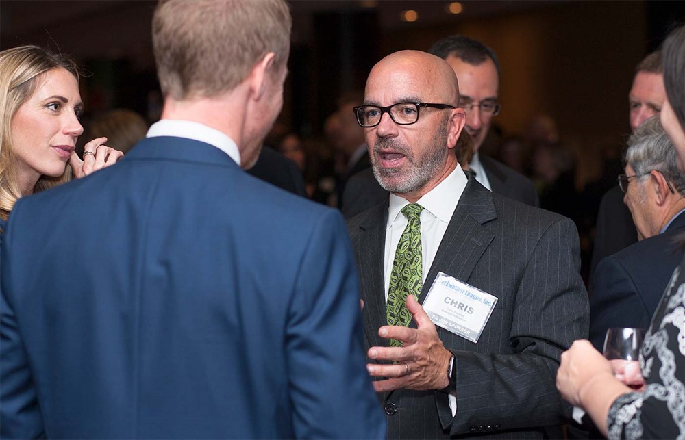 Silver Sponsor DeRoyal’s Chris Schulze chats with Corporate Sponsor MedSpeed’s Jake Crampton (left, back to camera).