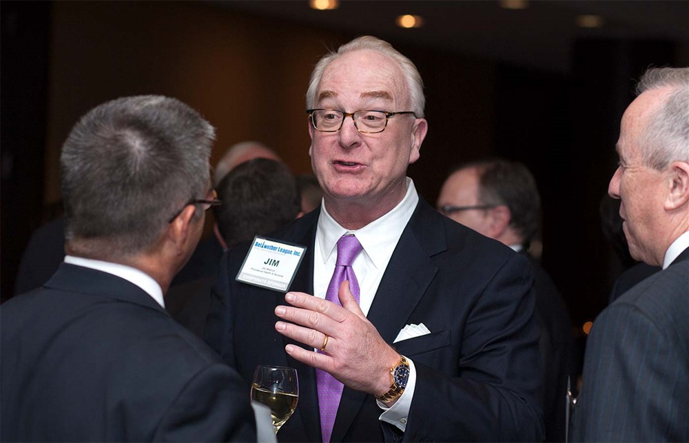 Providence’s Jim Wetrich (center) emphasizes a point with Bellwether League Inc. Board Member Mark Van Sumeren (left) and Corporate Sponsor Johnson & Johnson Health Care Systems’ Larry Malloy (right).