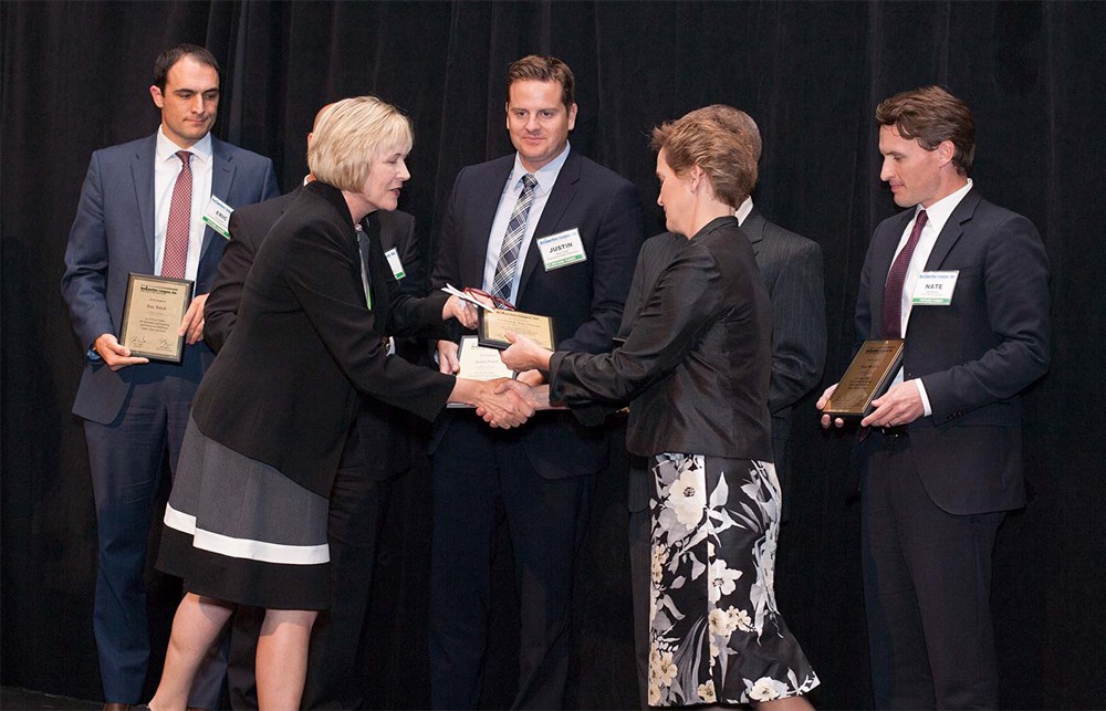 Bellwether League Inc. Treasurer Mary Starr greets Donna Van Vlerah (Future Famers Class of 2015) as her fellow classmates look on.