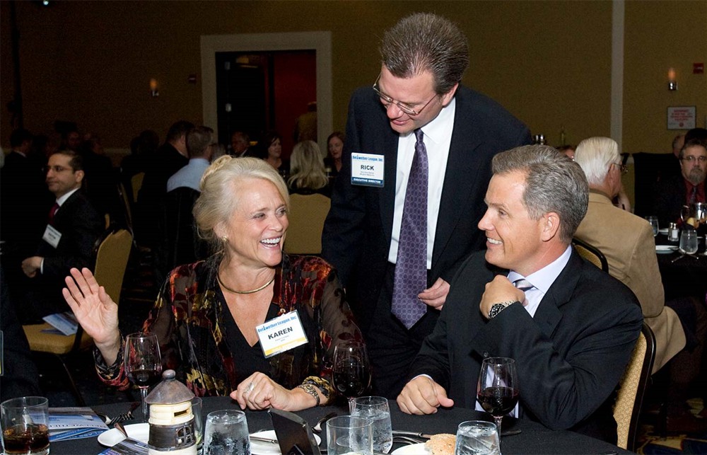 Bellwether League Inc.’s Rick Dana Barlow (center) checks in with Gold Sponsor GHX’s Karen Conway (left) and Bruce Johnson (right).