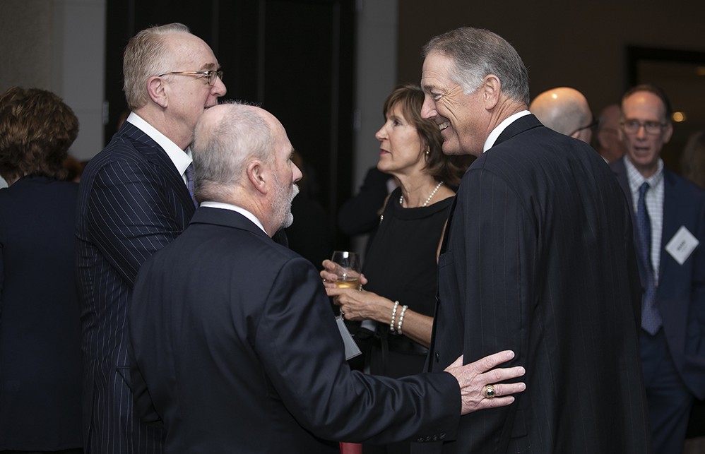 Jamie Kowalski chats with Carl Meyer with The Wetrich Group’s Jim Wetrich (far left) and Amy Meyer (Carl’s wife) in the background.