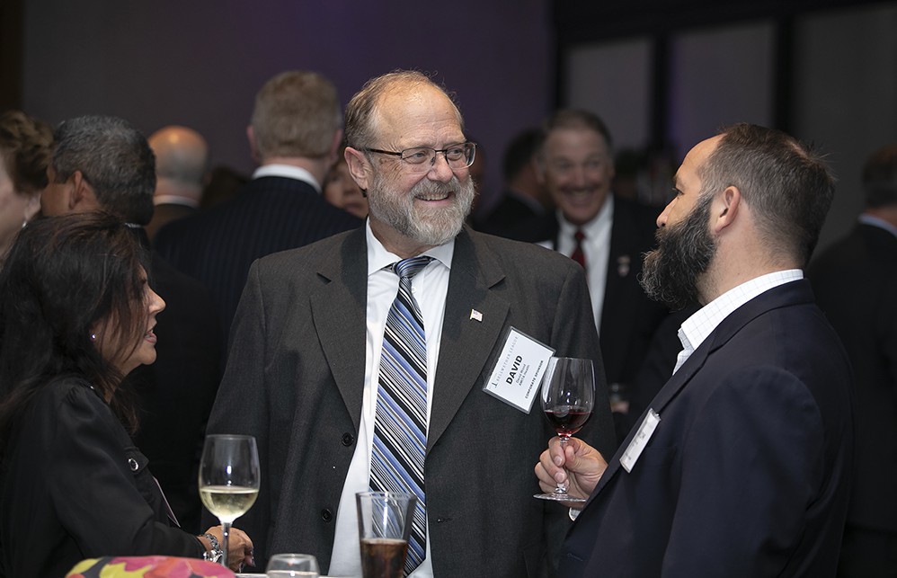 AMITA Health’s David Wood chats with Founding Sustaining Sponsor Premier’s Haakon Midness and Martine Aversa.