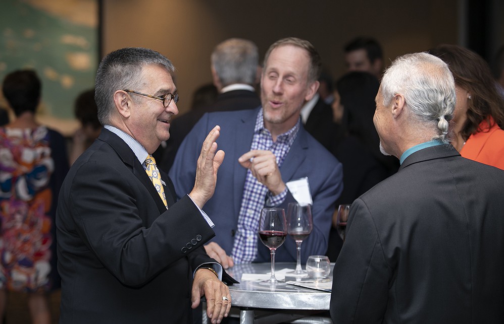 Bellwether League Board Member Mark Van Sumeren (left) converses with MedSpeed’s Jake Crampton and Nick Gaich (back to camera).