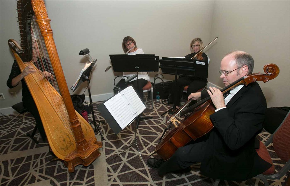 The flute and string trio regale attendees.